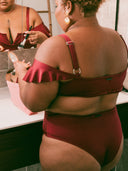 Maillot deux pièces à voilage de couleur bordeaux porté par une femme ronde de dos